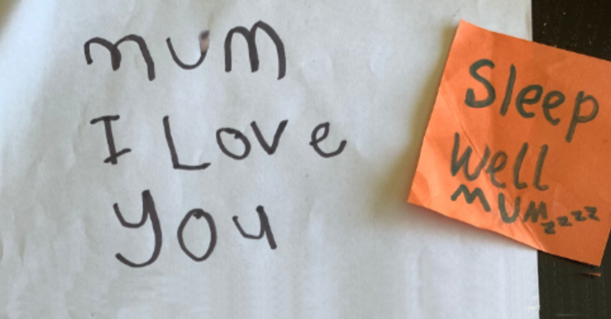 A handwritten note from a child reads mum i love you with a post it not say sleep well mum stuck on it.