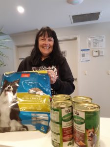 Jane with some of the donated pet food